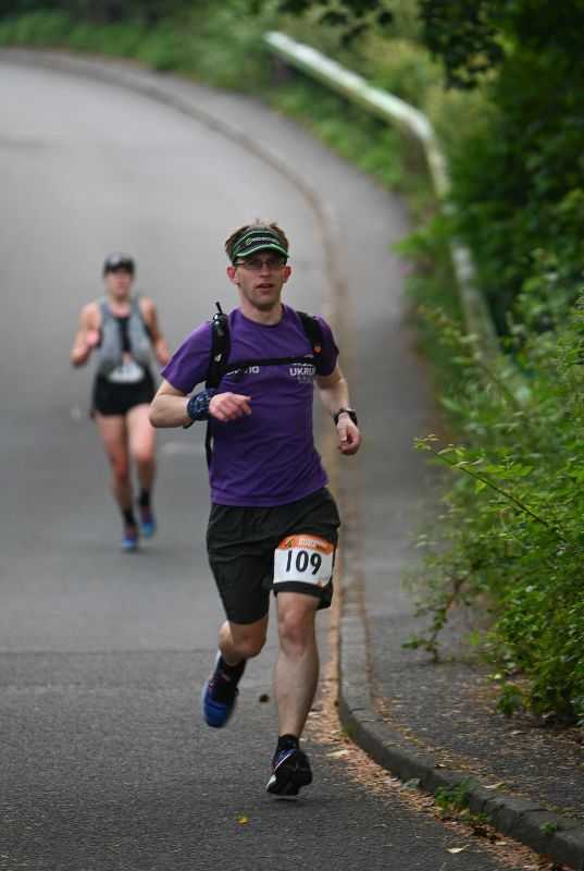 Runners going downhill on a road