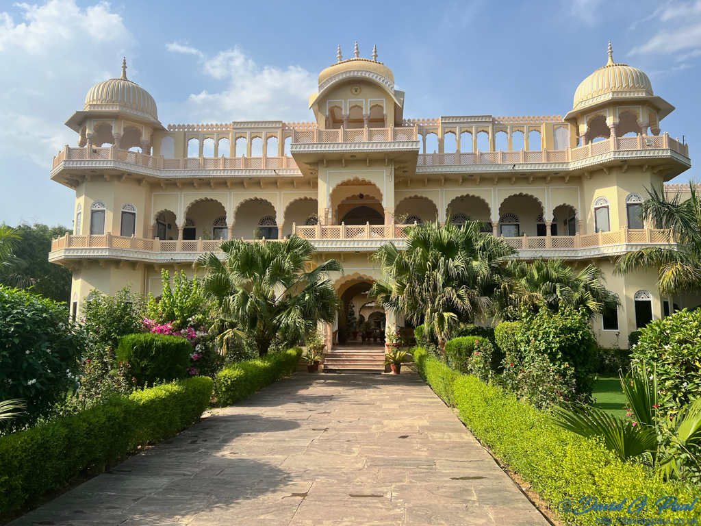 A faux-colonial style building with a garden in front