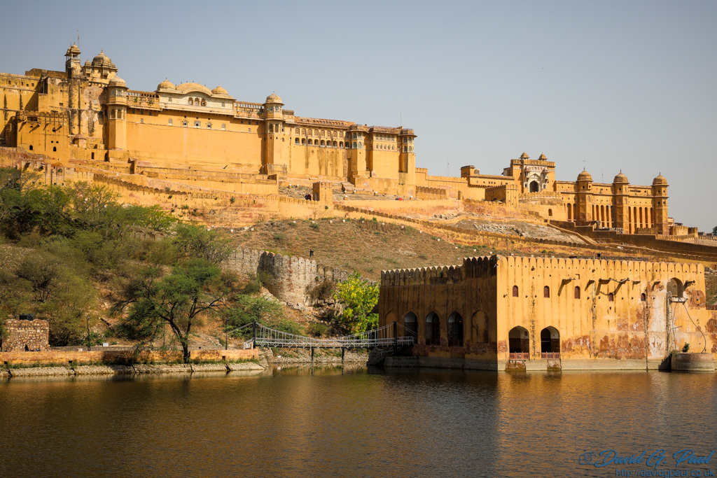 A sandstone fortress sits across a lake