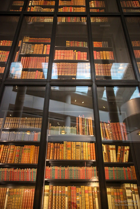 Light reflecting off a glass in front of a tall bookcase