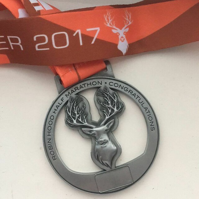 An orange ribbon attached to a medal depicting a stag