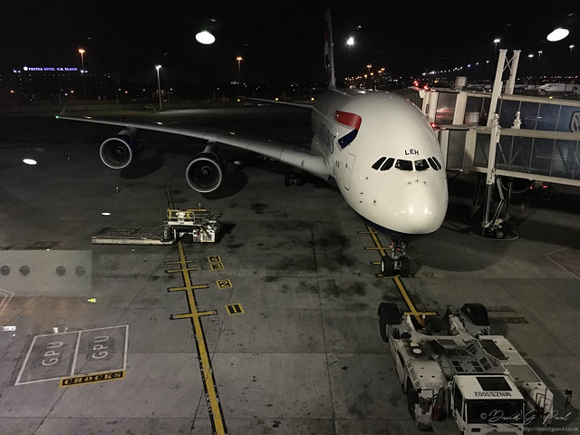 An aircraft standing at the gate at night