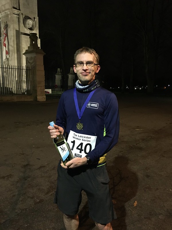 Third place finish holding wine given as prize