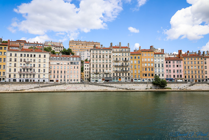 Looking across a river to a row of colourful buildings