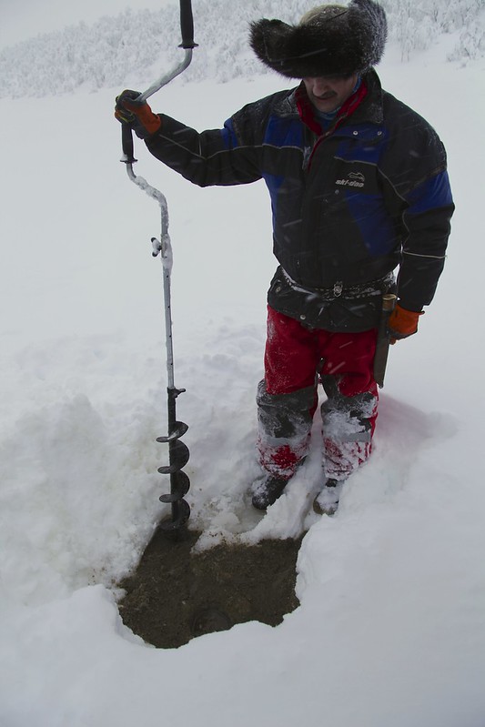 Oskar preparing a hole for ice fishing