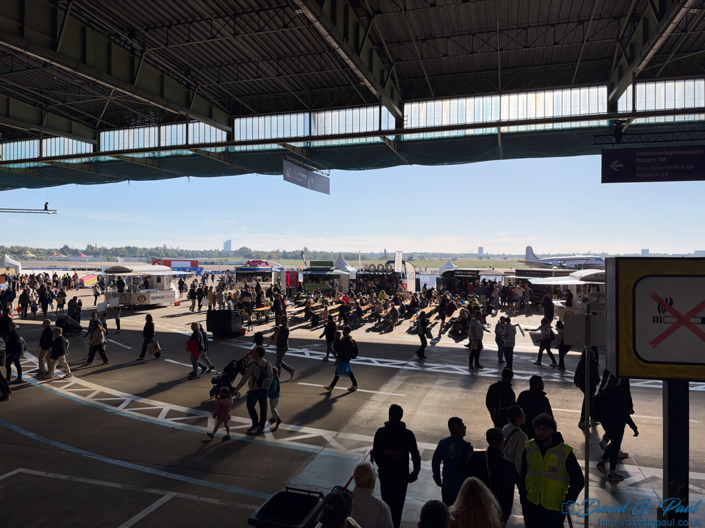 People walking around the repurposed hanger of Templehof